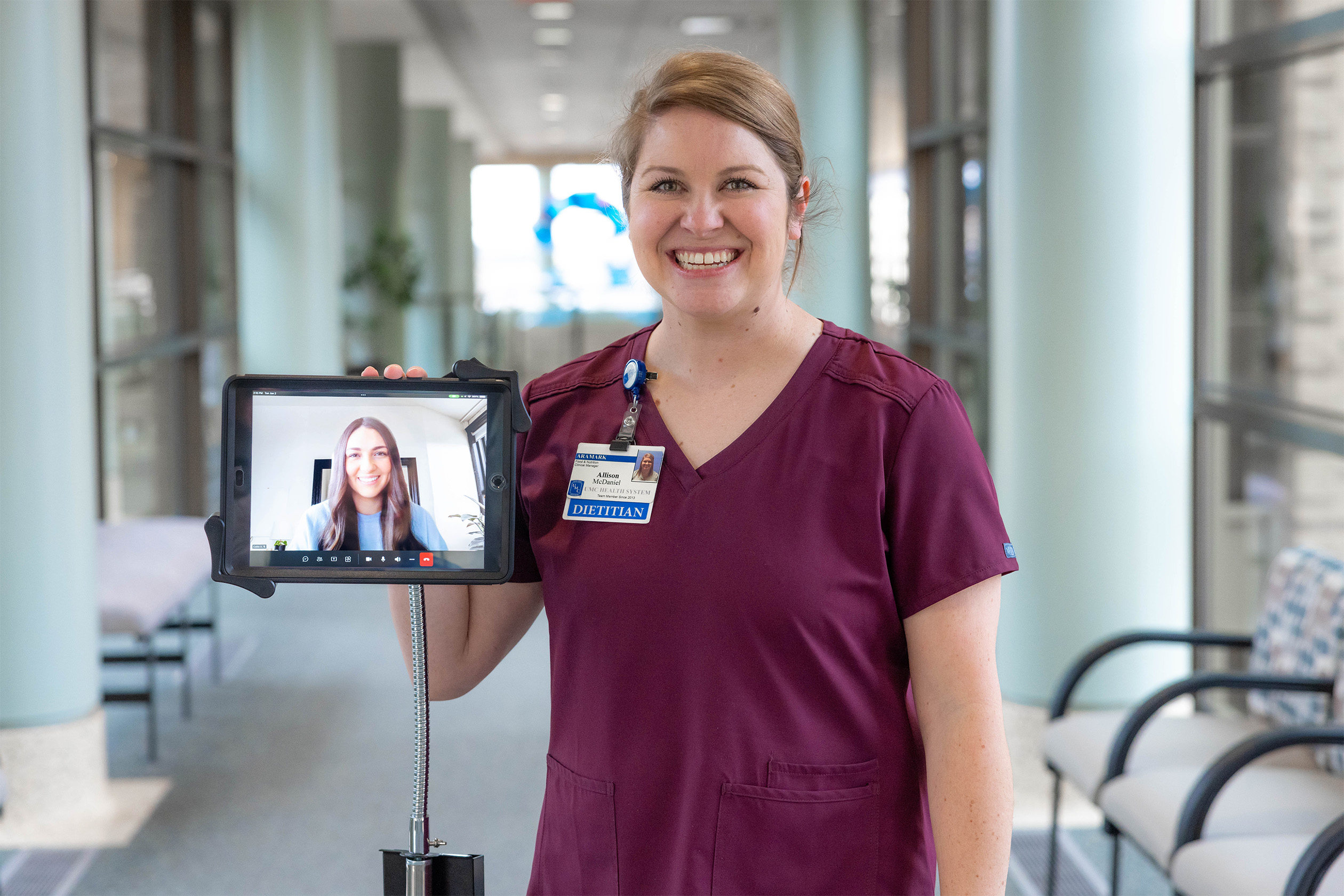 Healthcare worker holding mobile phone with teleheath on screen